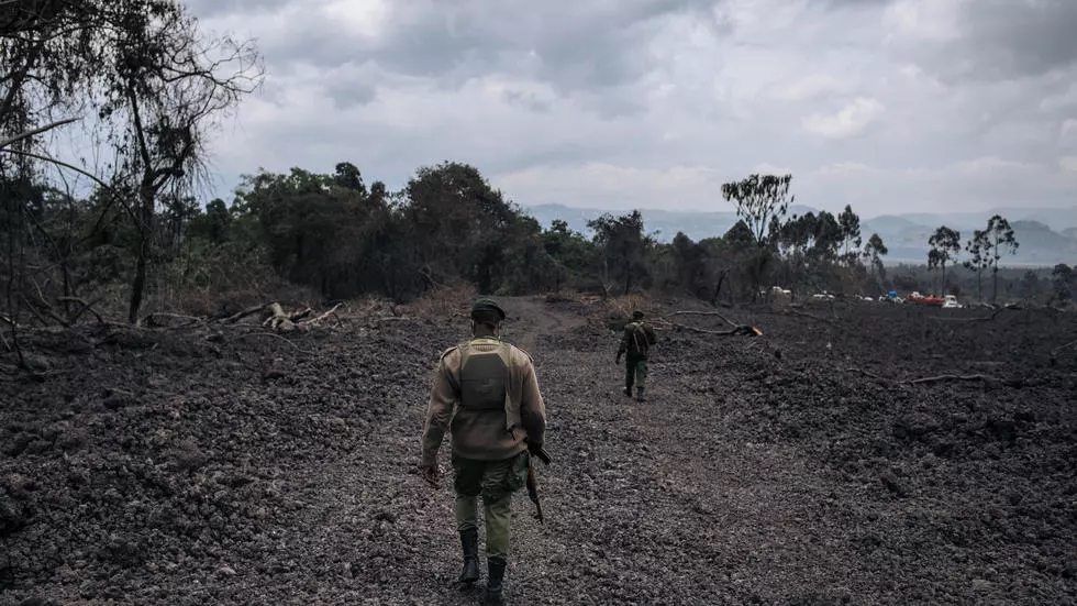 Virunga National Park rangers guard the high voltage power line construction site on the solidified lava flow of the Nyiragongo volcano